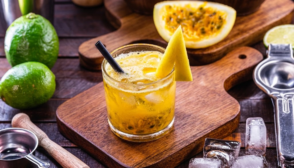 Refreshing Passion Fruit Cocktail served with fresh lime and tropical passion fruit