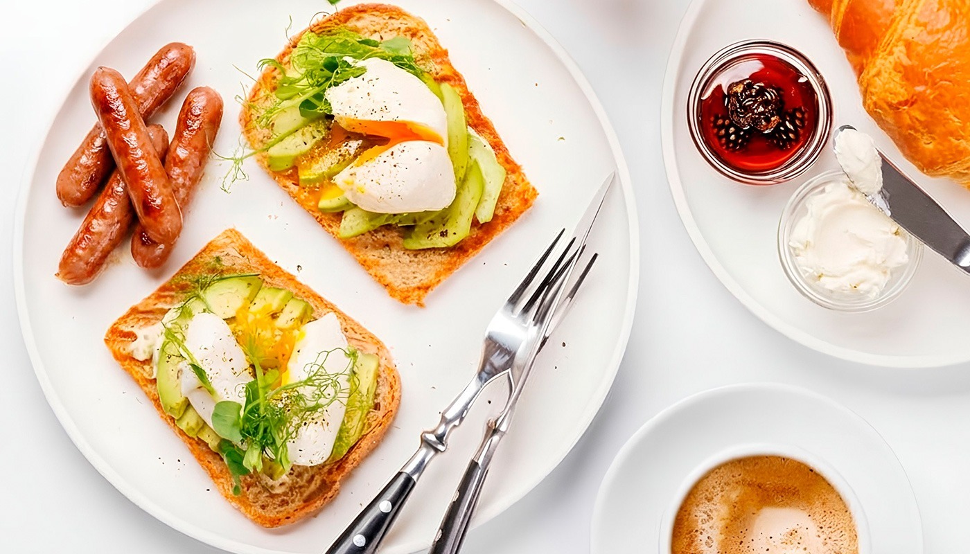Breakfast and brunch selection featuring avocado toast, poached eggs, sausages and coffee at Roatan Provision.