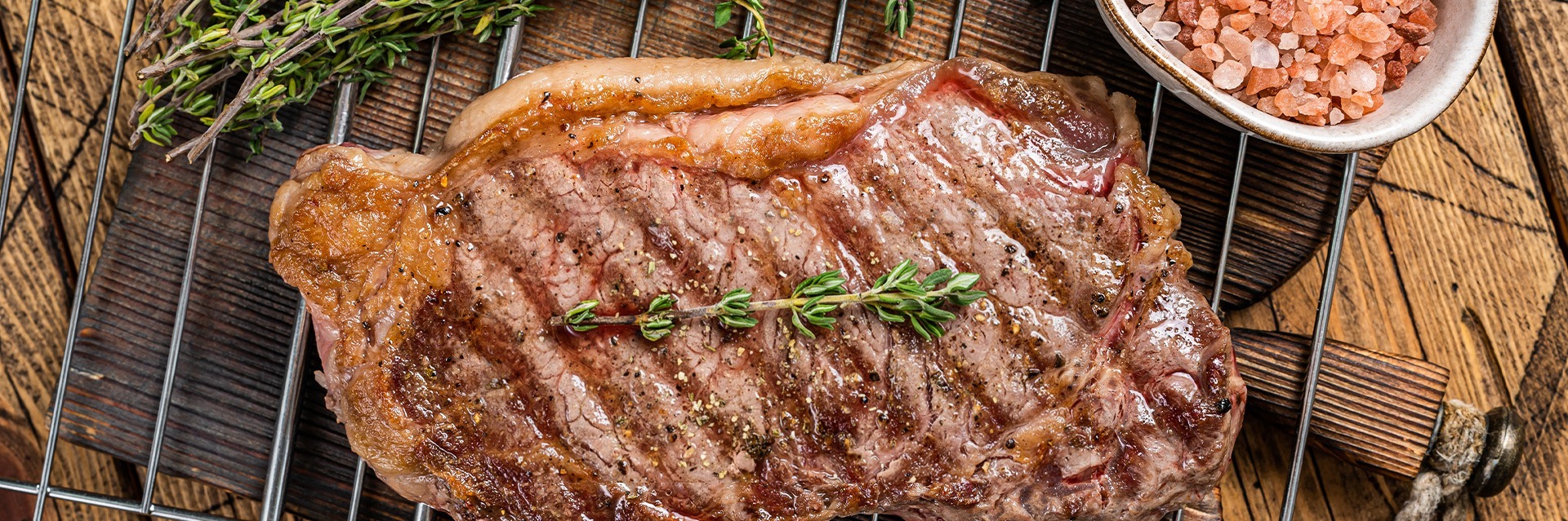 Grilled ribeye steak with garlic butter and herbs served as a premium BBQ dish at Roatan Provision.