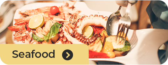 Fresh seafood selection including octopus and gourmet seafood dishes at Roatan Provision